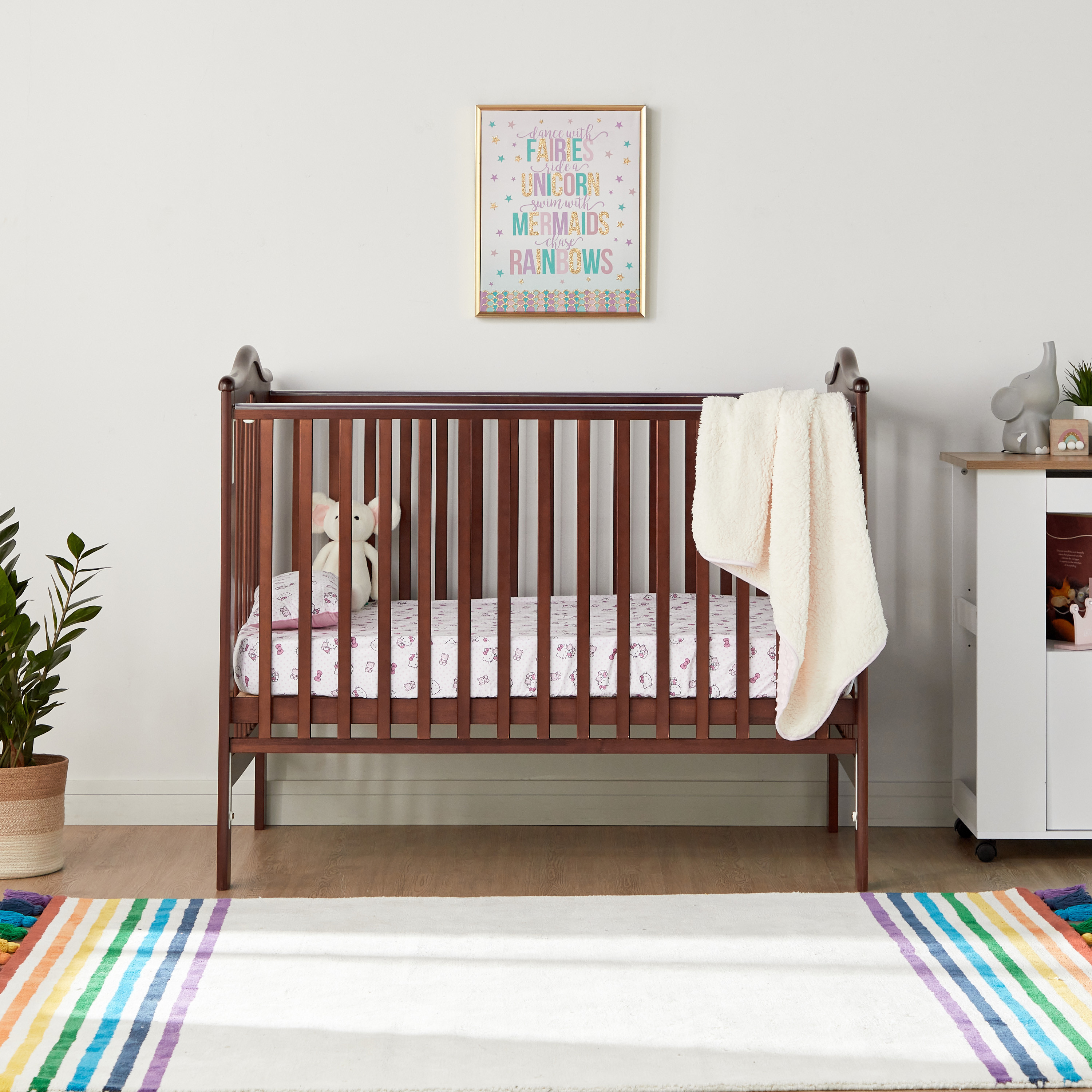 Crib with adjustable clearance rail