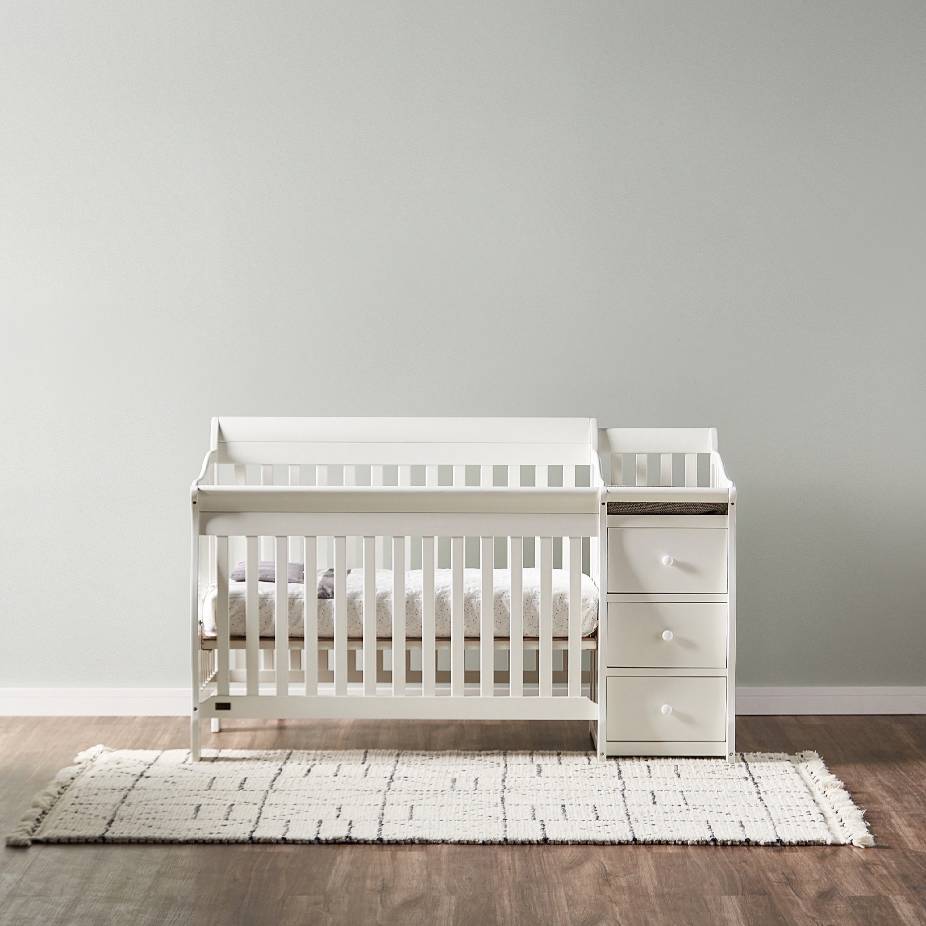 Crib with outlet storage drawers