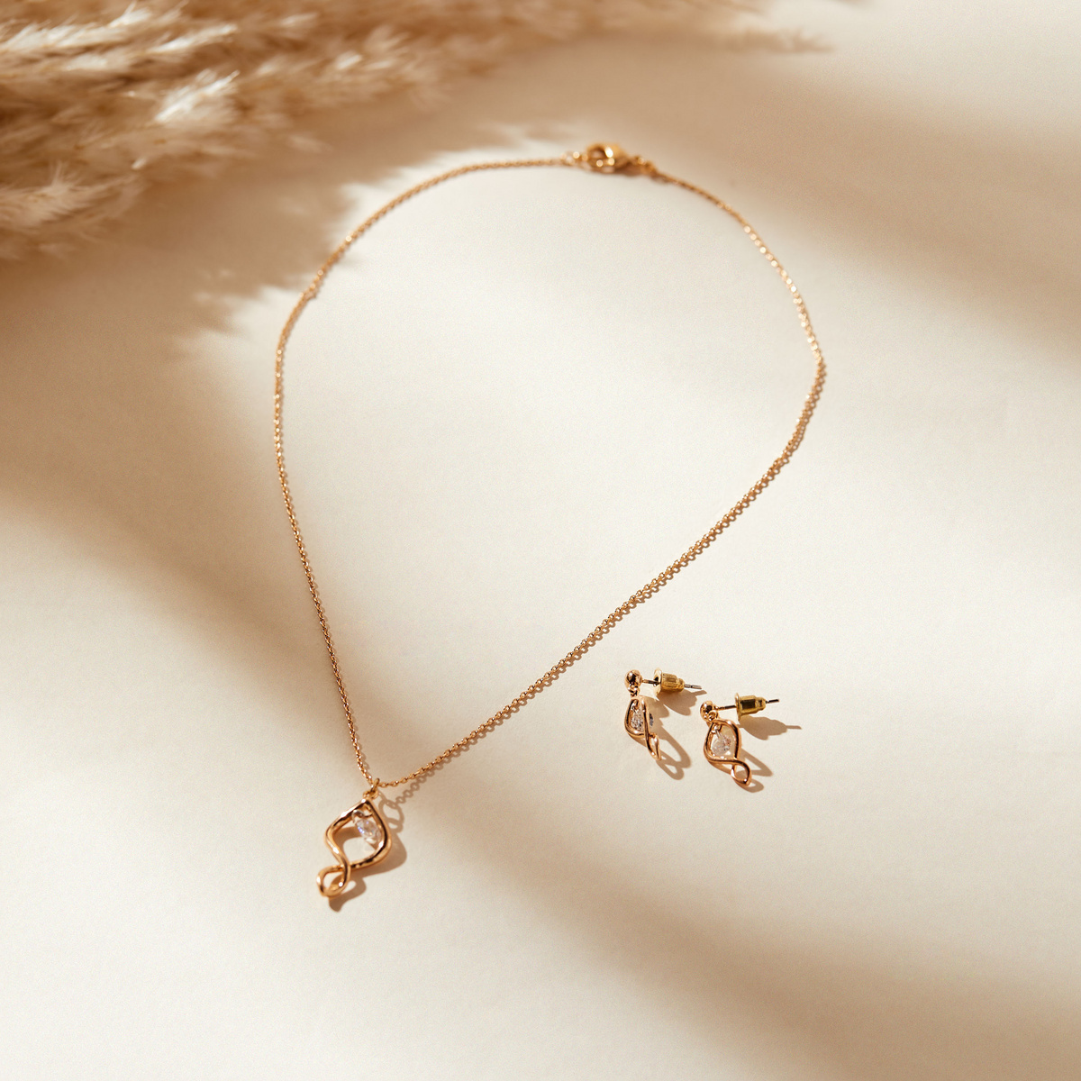 Cubic Zirconia Studded Metallic Pendant Necklace and Drop Earrings Set