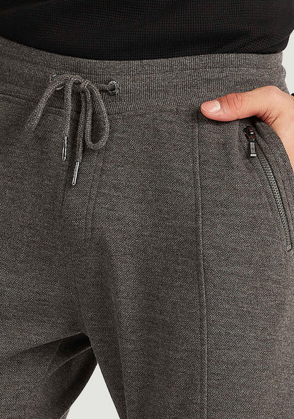 Iconic Solid Jog Pants with Drawstring Closure and Zipper Pockets