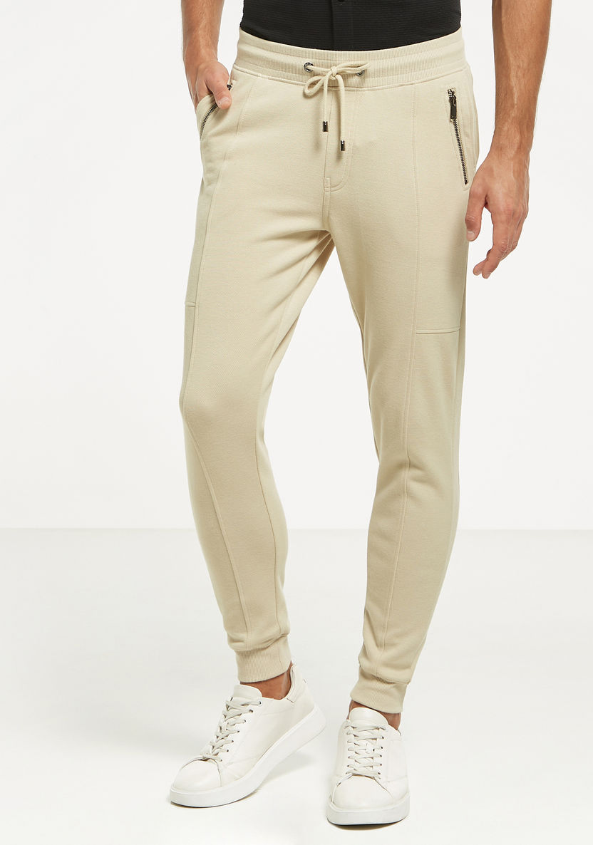 Buy Solid Jogger Pants with Zipper Pockets and Drawstring Closure