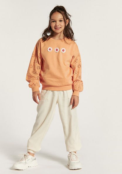 Juniors Schiffli Detail Pullover with Floral Accents and Long Sleeves